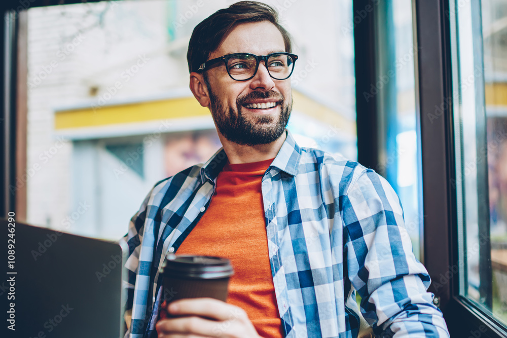 Aufkleber dreaming smiling bearded young man looking out of window and thinking on creative ideas for developi