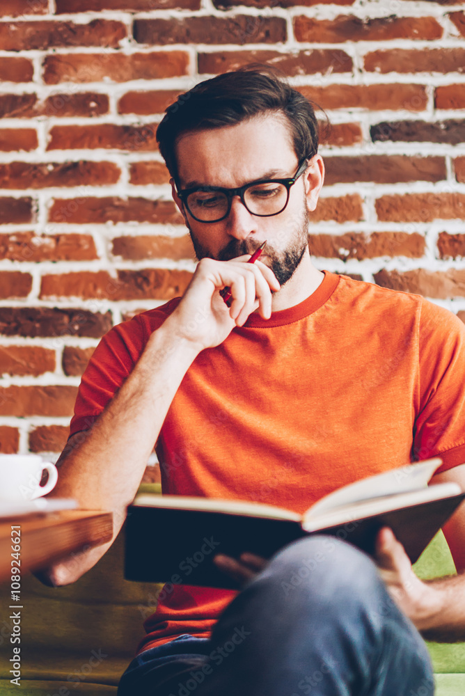 Aufkleber concentrated smart hipster student learning information from textbook preparing for seminar.pensive 