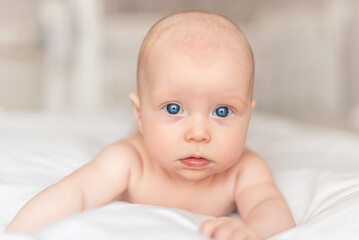 Baby girl with blue eyes close-up.