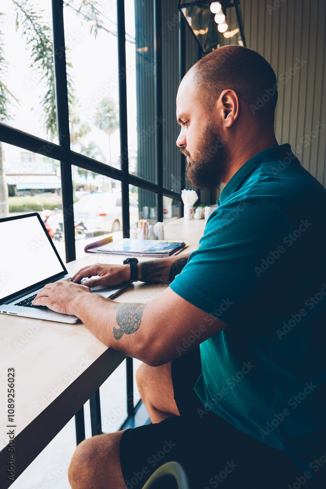 Aufkleber serious bearded male blogger typing message on laptop computer with mock up screen chatting in socia