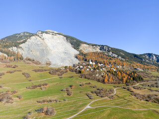 Aerial view of mountain village of Brienz Brinzauls in the Swiss Alps with rockfall in the...