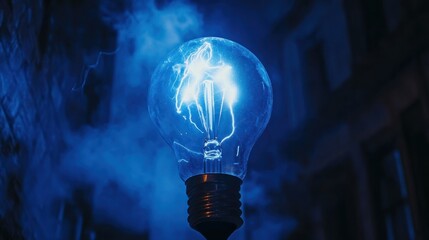 A glowing light bulb emits blue energy against a dark, smoky backdrop.
