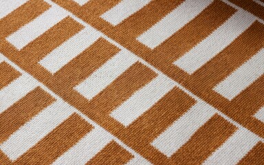 Fototapeta premium Beige brown knit texture. Warm autumnal hues in a textured knit fabric. Cozy and comforting design.