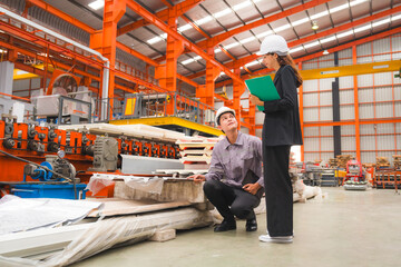 Obraz premium A female expertise engineering manager or inspector and Mechanic are checking or examining the quality of metal sheet product with an order of industry or factory, Business successful.