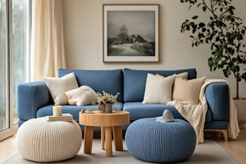 Two knitted poufs near dark blue corner sofa. Scandinavian home interior