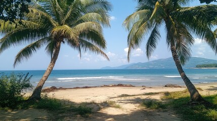 Fototapeta premium Tropical beach scene featuring lush coconut palm trees framing a tranquil shoreline with gentle waves and distant hills under a clear blue sky.