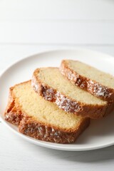Freshly baked sponge cake on white wooden table, closeup