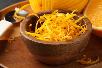 Fresh orange zest in wooden bowl, closeup