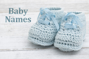 Baby Names message with blue baby booties crochet on wood