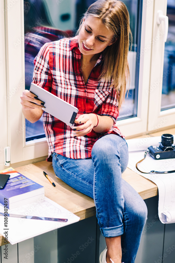 Poster young female student using portable pc for playing online games on break during preparing homework t