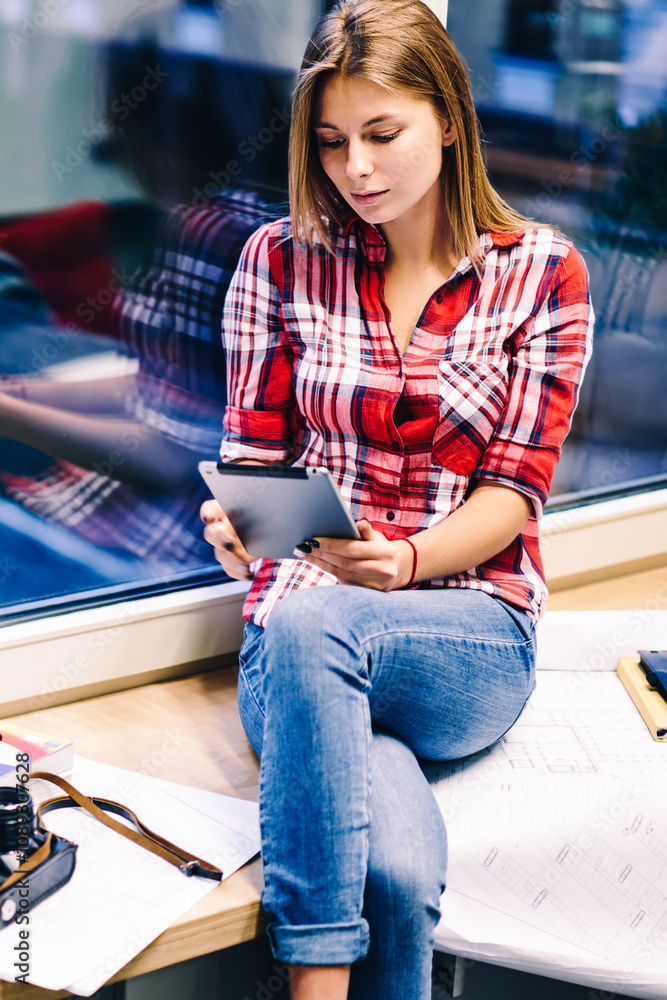 Poster creative female designer updating content in flog via tablet editing photos using technology before 