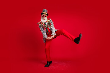 Full size photo of happy cheerful old man fooling dance wear christmas tree balls costume sunglasses isolated red color background