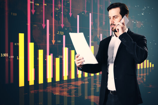 Attractive stressed young businessman holding document and talking on the phone glowing red business chart and map on blurry background. Crisis, financial fall and recession concept. Double exposure.