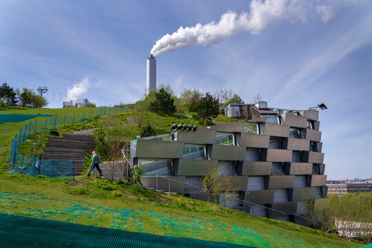 People in public space on the roof of Amager Bakke known as Amager Slope or Copenhill, power waste to energy plant with recreational facility in Copenhagen, Denmark