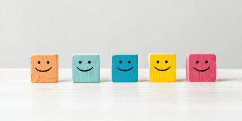 Five colorful wooden blocks with smiley faces arranged in row, evoking joy and positivity. Perfect for children decor or educational materials