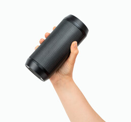 Close-up portable wireless speaker in hand isolated on white background. Black mobile wireless bluetooth speaker with ribbed texture in female hand. Case made of porous texture Bottle-Shaped.