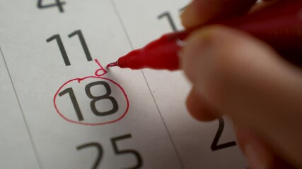 Woman hand with pen writing reminder Dinner in calendar, close-up