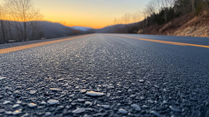 Reflection of a sunset over a wet mountain road after rain