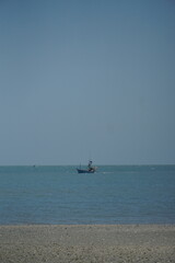 Fototapeta premium Fishing boat in tranquil waters coastal scene photography serene environment distant view nature's beauty