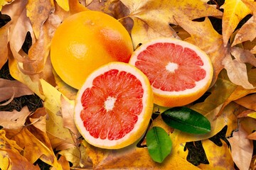 Red fresh ripe grapefruits slices on background.