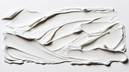 Close-up of white creamy substance with smooth, textured swirls on a flat surface, resembling thick paint or cosmetic cream, creating an abstract pattern with subtle shadows.