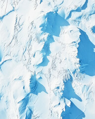 Pristine snow surface with delicate patterns illuminated by soft shadows under a blue tint