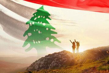 Lebanon flag waving in the sky. A couple hike and enjoy a break look at the top of the mountain adventure travel. Lebanon national flag for independence day.