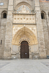 A detailed view of the intricately carved Gothic archway of the Ávila Cathedral in Spain, featuring floral and geometric designs. Perfect for architecture and historical themes