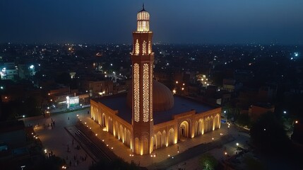 Illuminated mosque at night, aerial view.
