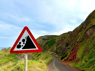Falling Rocks Warning Sign on a Scenic Coastal Road