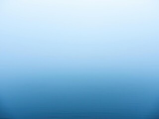 Obraz premium Light blue misty fog rolling in over a calm lake with a silky smooth surface and clear water, still water, peaceful lake scene