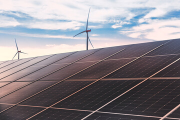 Solaranlage und Windrad bei Sonnenuntergang
