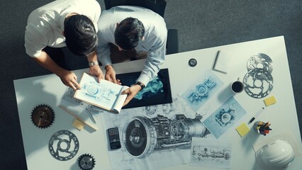 Top down aerial view of manager sitting while answer question about jet engine. Professional...