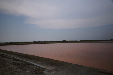 Fototapeta premium Salt harvesting process coastal salt flats photography natural landscape wide-angle view sustainable agriculture