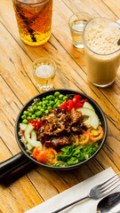 Beef Black Pepper Poke Bowl served on the table with Cappuccino and Iced Tea