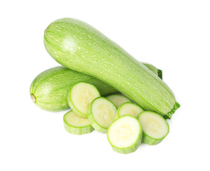 Fresh whole and cut zucchinis isolated on white, above view