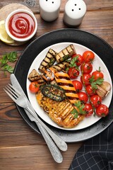 Delicious grilled vegetables and chicken breast served on wooden table, flat lay