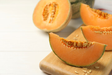 Cut ripe Cantaloupe melon on white table, closeup. Space for text