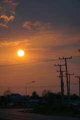 Sunset over rural landscape with power lines scenic view nature photography tranquil environment evening atmosphere