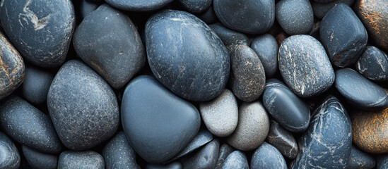 Textured collection of smooth black stones in natural arrangement