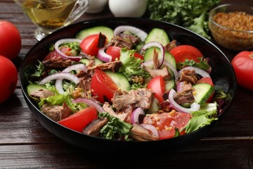 Delicious fresh tuna salad on wooden table, closeup