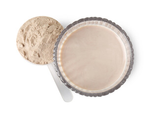 Delicious protein shake in glass and scoop with powder isolated on white, top view