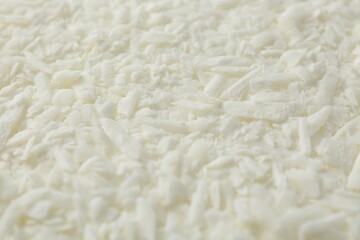 White soy wax flakes as background, closeup