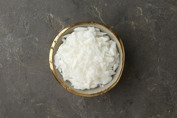 Soy wax in bowl on grey table, top view