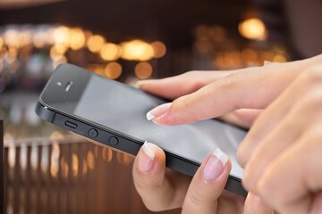 Hand typing on phone for social media