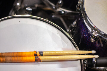 Drum sticks on drums with no people around.