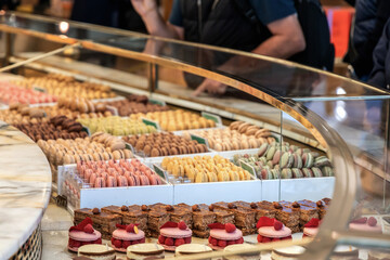 Various assortment of desserts confectionery on the counter in a bakery