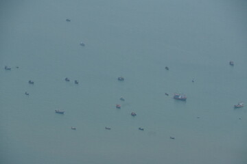 Fishing vessels at dusk ocean view aerial photography tranquil waters wide angle maritime serenity