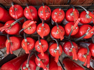 a lot of red fire extinguisheres top view