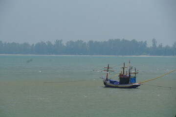 Fishing boat anchored in calm waters coastal region nature photography serene environment overcast sky tranquility and reflection